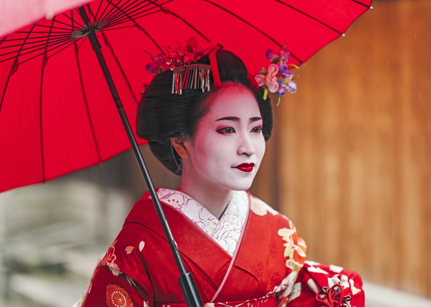 Maiko geisha walking on a street of Gion in Kyoto Japan